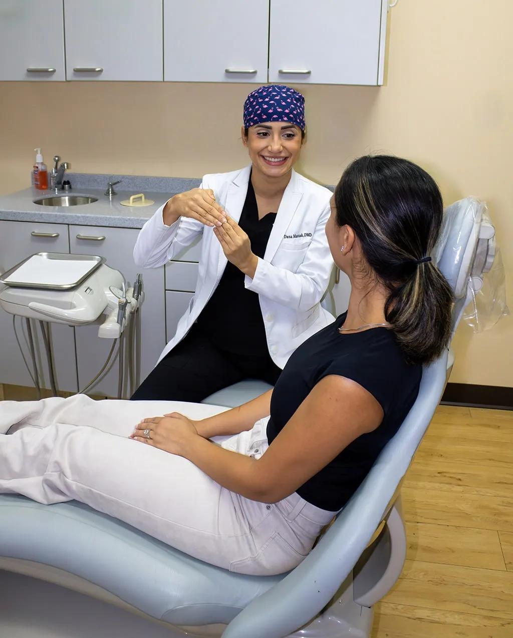 Dentist and patient reviewing a dental model on a screen in an operatory.