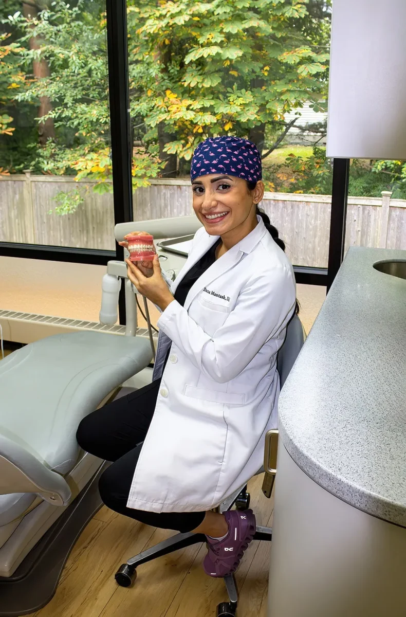Dentist performing a demonstration on a dental model in the operatory.
