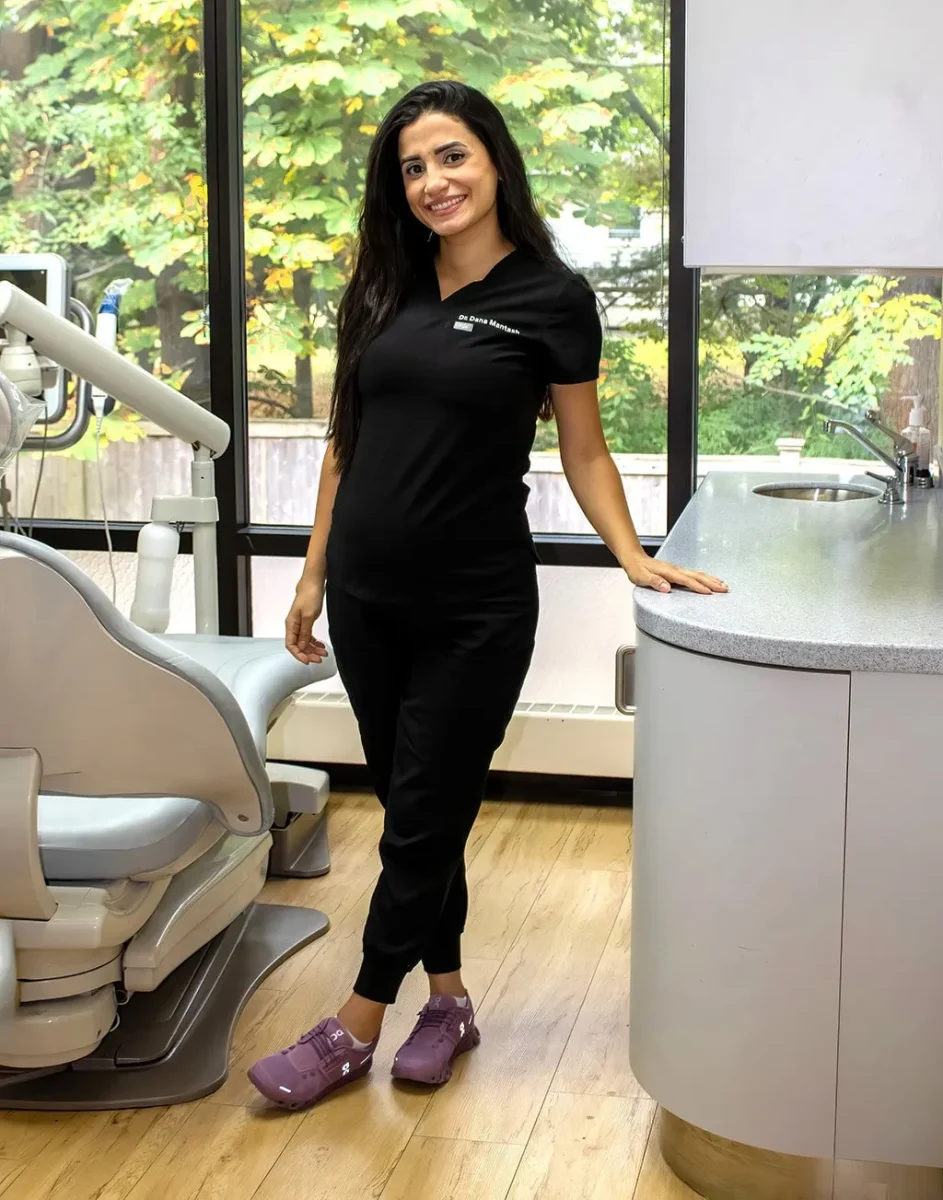 Dental hygienist standing in a dental procedure room