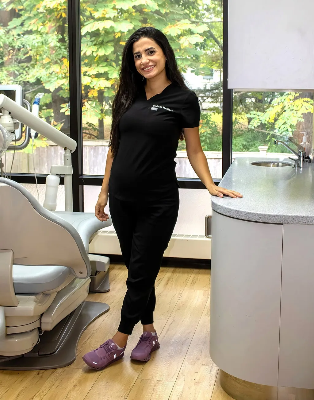 Dental hygienist standing in a dental procedure room